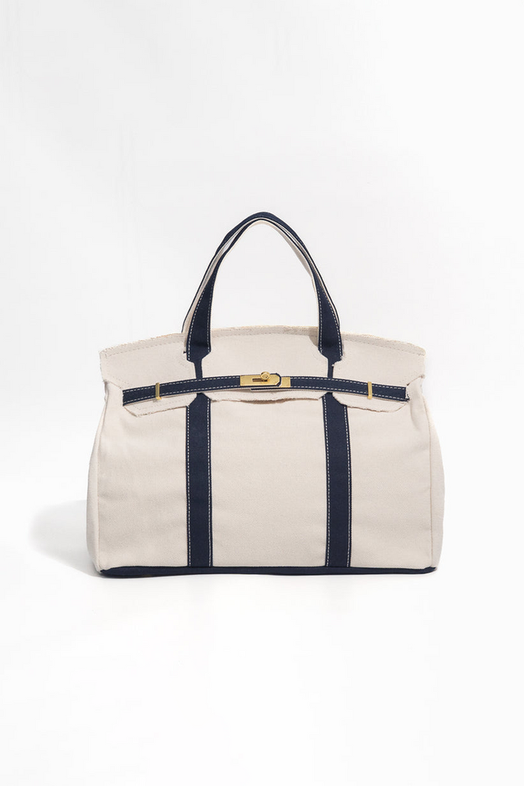 Beige handbag with navy accents on a white background