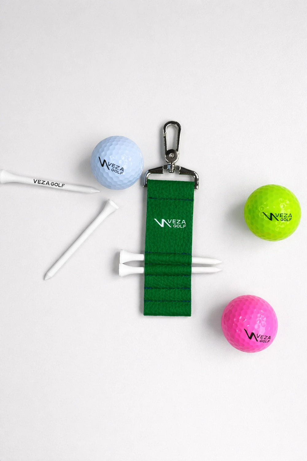 Veza Golf products including golf balls, tees, and a strap on a white background