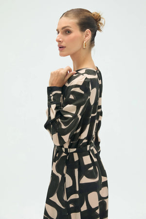 Side upper-body view of women’s inkbrush geo midi dress highlighting tie-front neckline