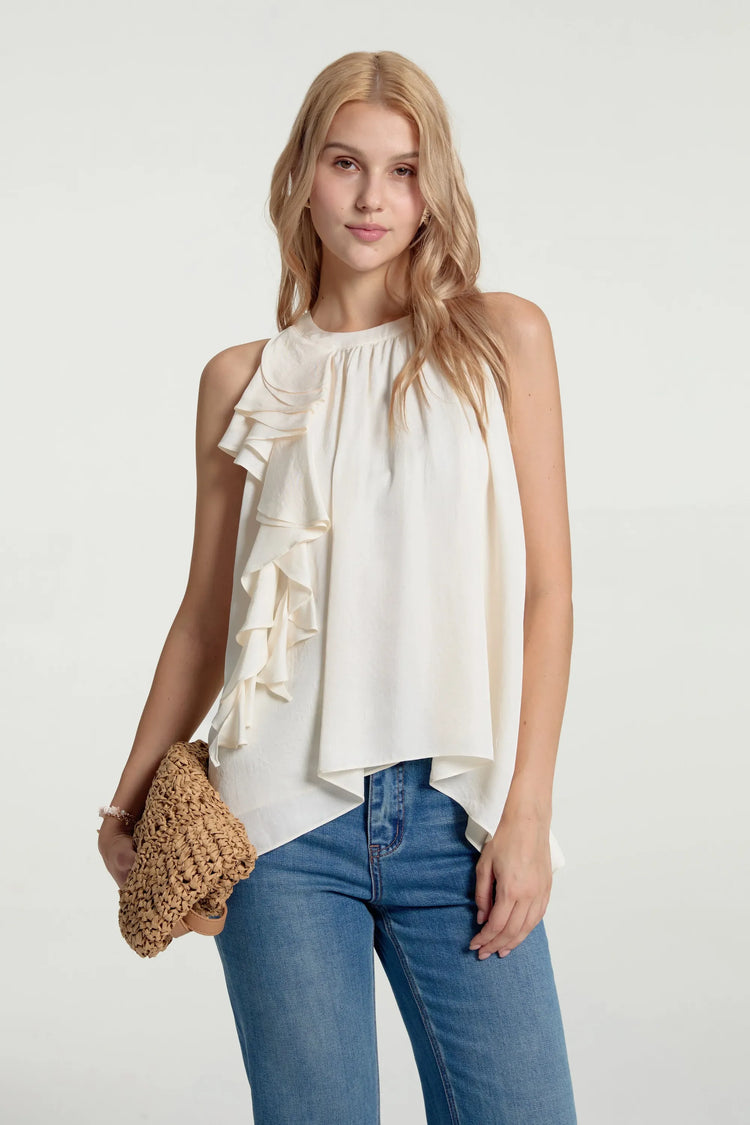 Asymmetrical ruffle halter top styled with blue jeans and a handbag, front view on grey background