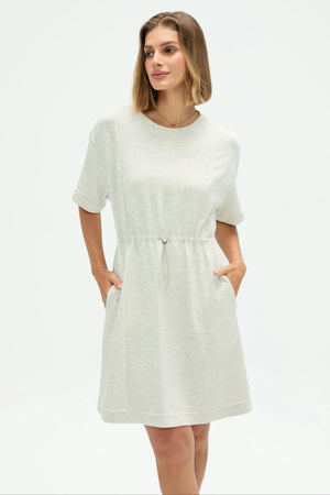 Women’s heather mist T-shirt dress showing relaxed fit and pockets, half-body front view