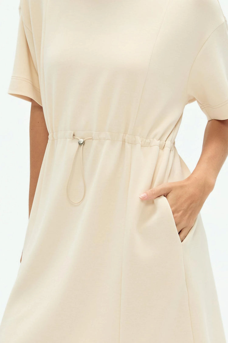 Close-up of soft oatmilk Tencel T-shirt dress fabric showing smooth texture