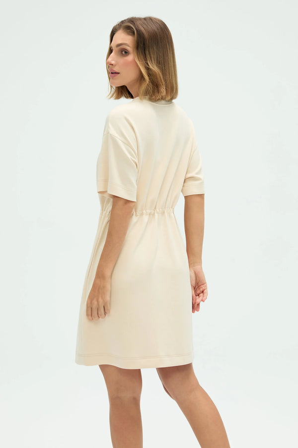 Back view of women’s soft oatmilk cinched T-shirt dress showing clean silhouette