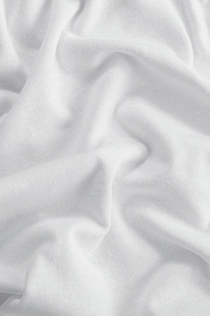 Close-up of white cotton linen tank fabric showing soft texture and subtle structure