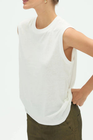 Close-up of white cotton linen tank fabric showing soft texture and subtle structure