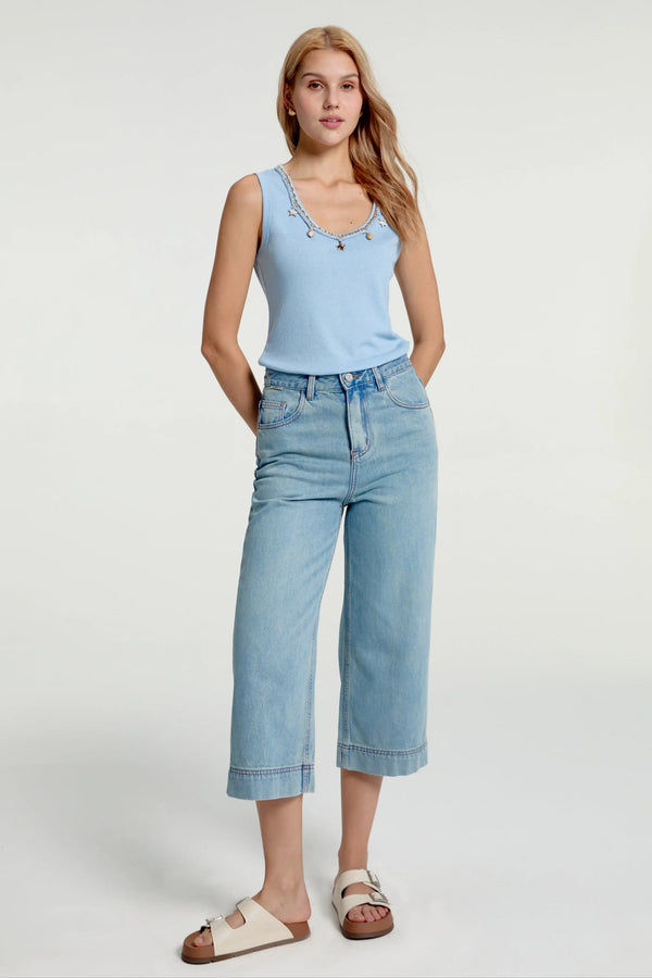 Cropped wide-leg jeans in soft fade styled with a blue tank, front view