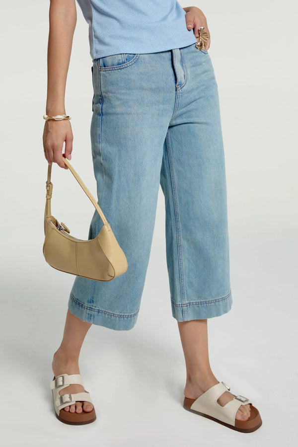 Side view of cropped wide-leg jeans highlighting an easy, breezy silhouette