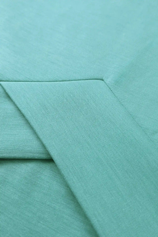 Close-up of breathable Tencel™ fabric showing a smooth, lightweight texture