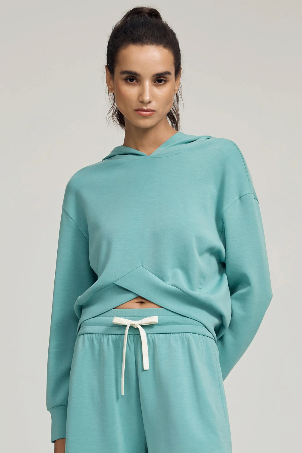 Crossover hem hoodie in seafoam blue styled with matching shorts, front view