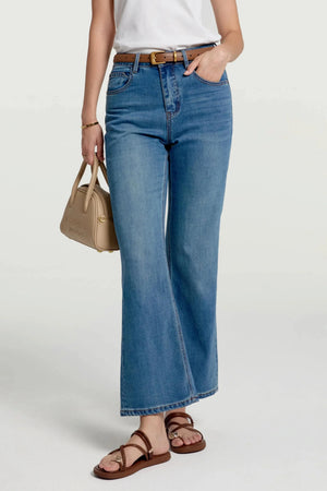Front view of stretch kick-flare jeans in a mid-blue wash with gentle fading