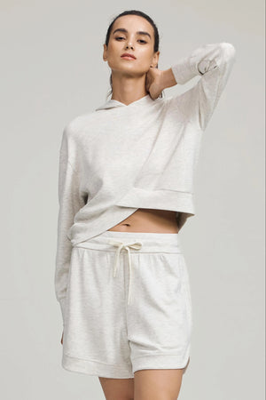 Light grey lounge shorts styled with a matching pullover for a coordinated look