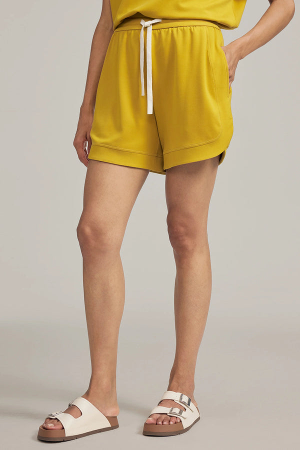 Front view of everyday lounge shorts in marigold yellow with a high-rise elastic waist