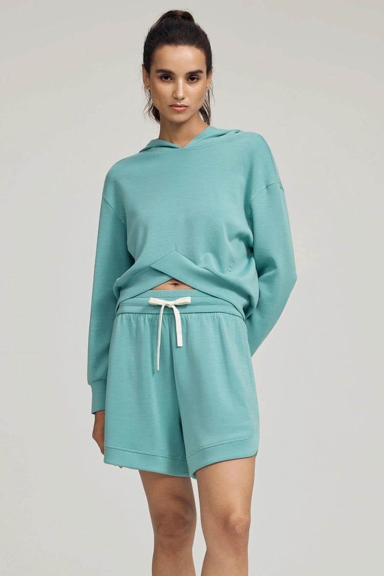 Seafoam blue lounge shorts styled with a matching pullover for a coordinated look