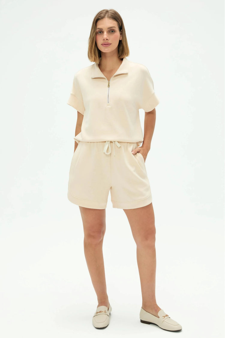 Oatmilk beige lounge shorts styled with a matching pullover for a coordinated look