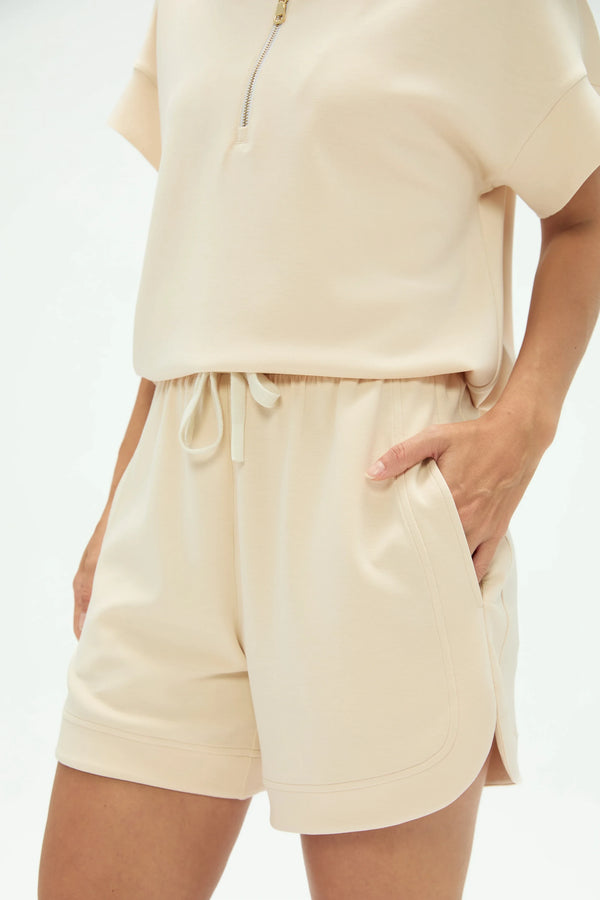 Side view of everyday lounge shorts in soft oatmilk showing a relaxed, breathable fit