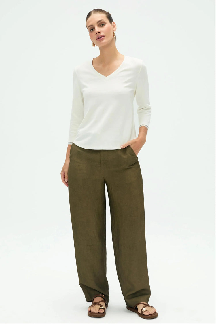 Women’s everyday V-neck top styled with olive green pants for a clean full-body look