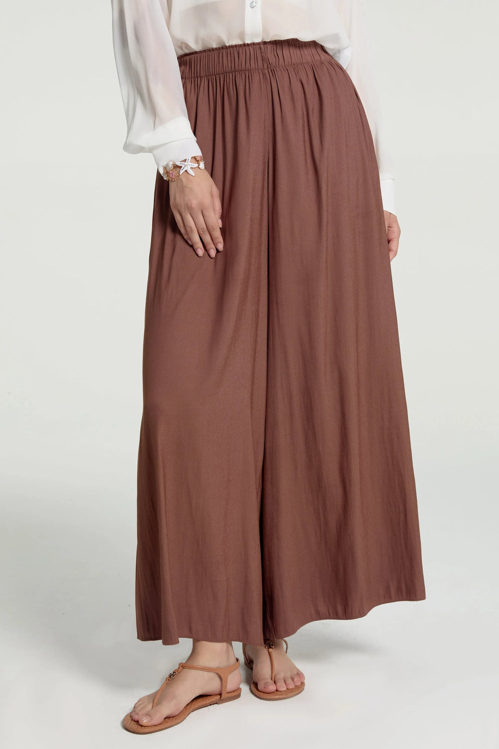 Flow drape palazzo pants styled with a white shirt, front view with a silky, wide-leg drape