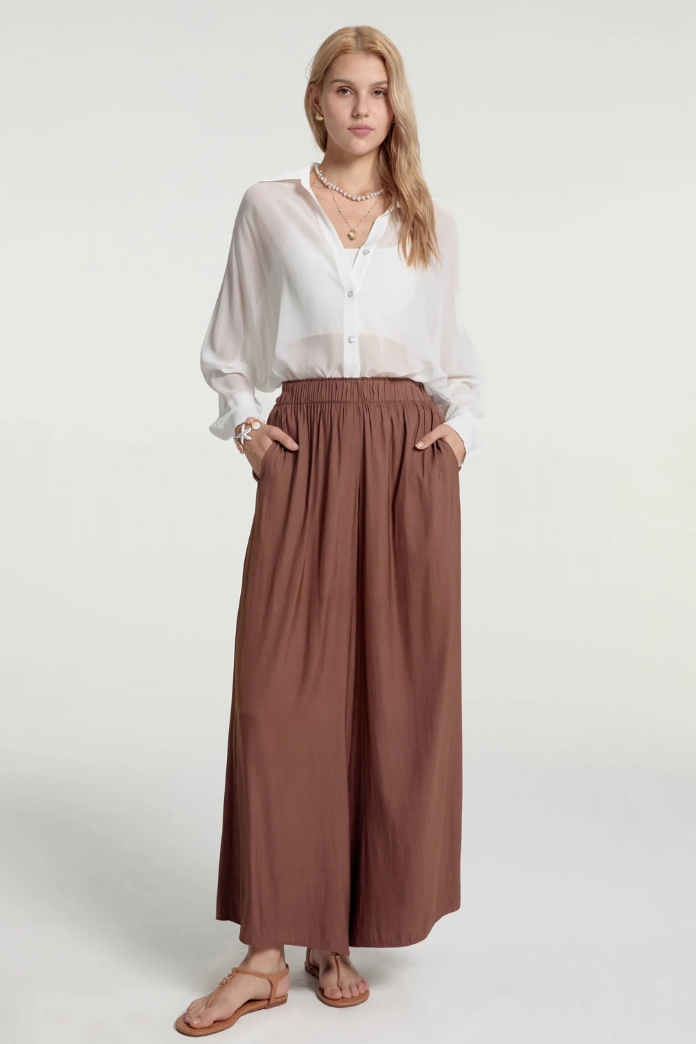 Flow drape palazzo pants styled with a white shirt, front view with a silky, wide-leg drape