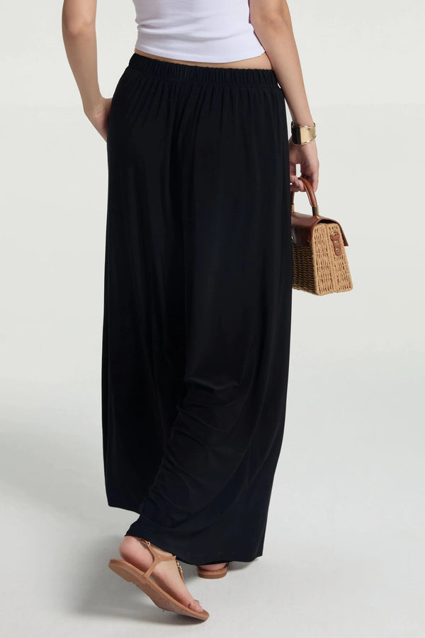 Back view of fluid wide-leg trousers with a clean, modern fit