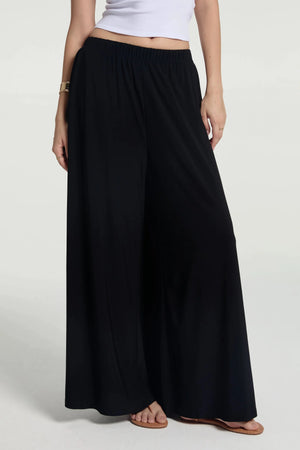 Front view of silky wide-leg trousers featuring a high-rise, fluid silhouette