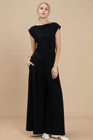 Silky wide-leg trousers paired with a black tank for an elevated, evening-ready look