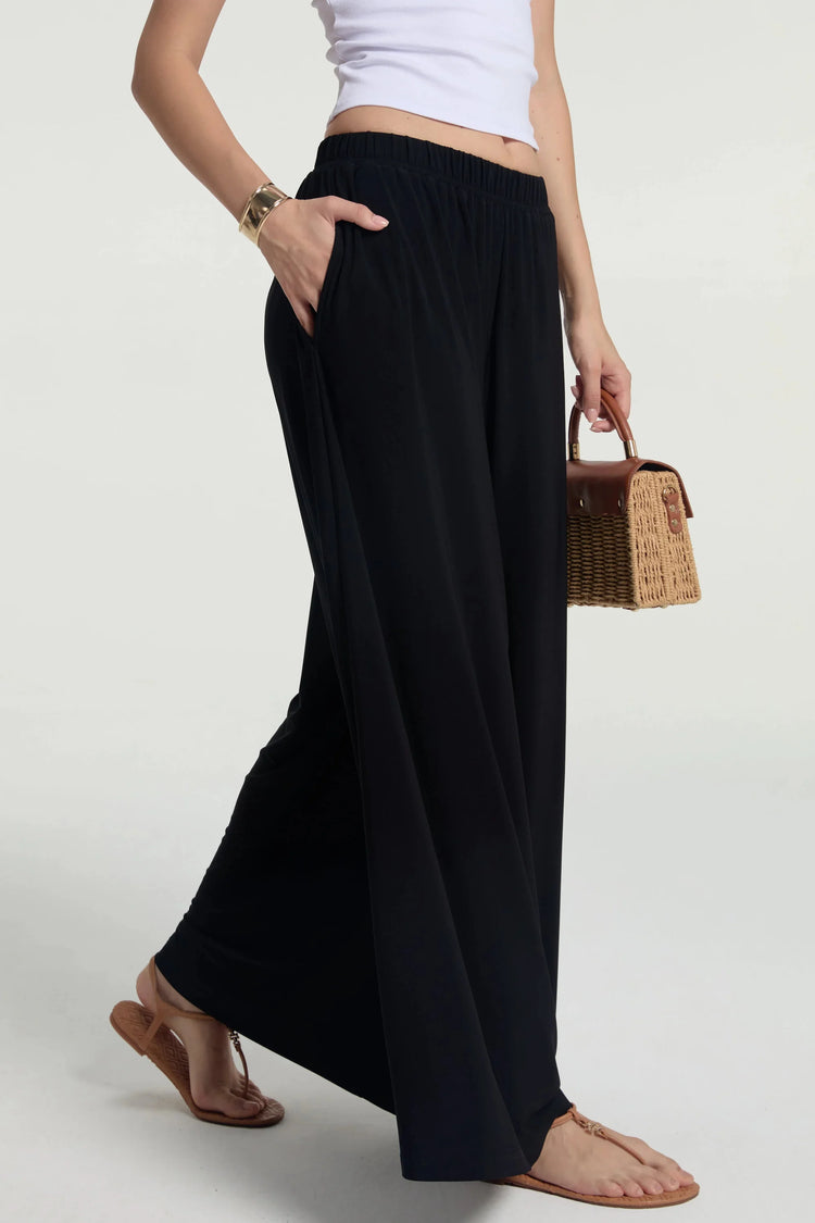 Side view of lightweight wide-leg trousers highlighting smooth movement and flow