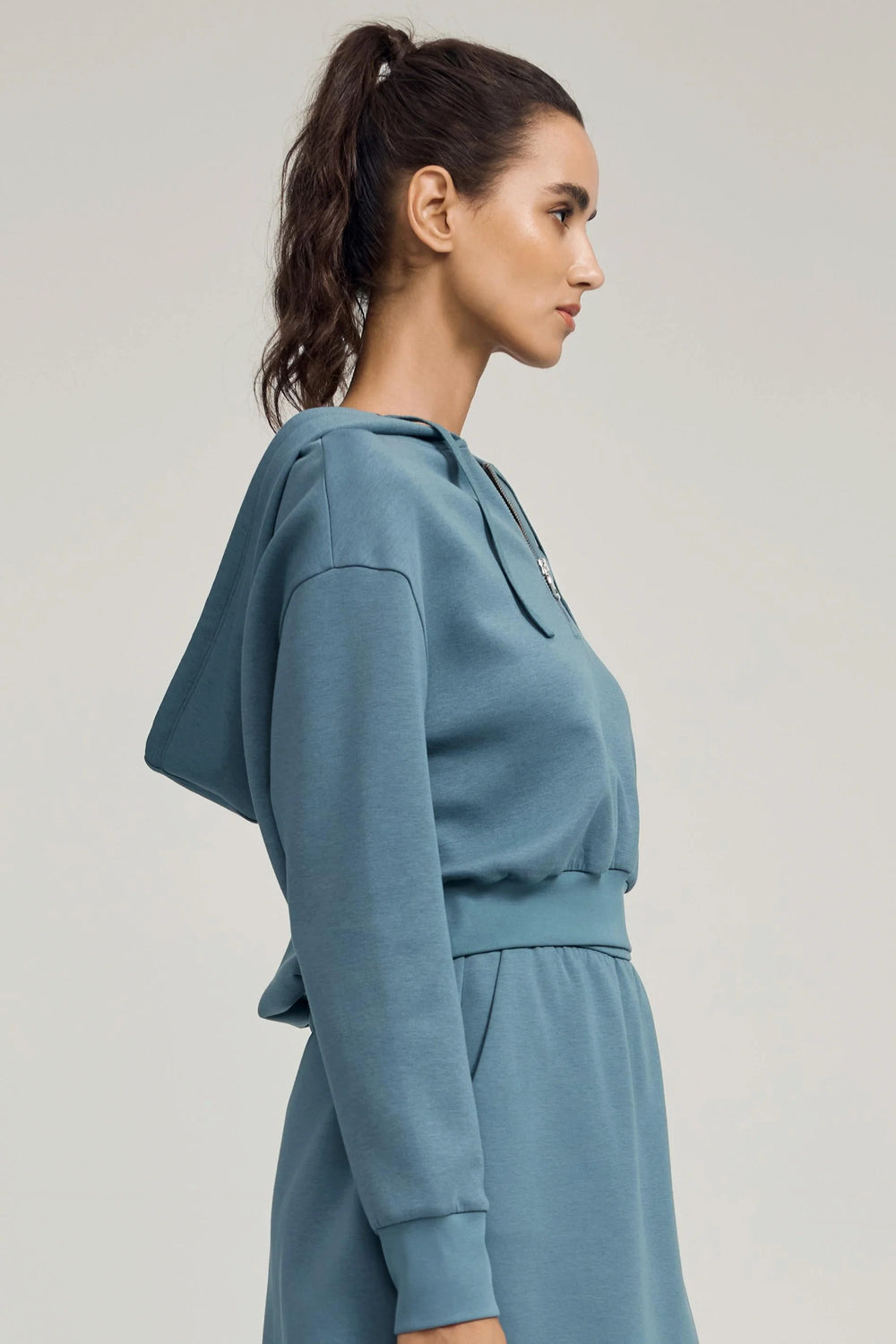 Women’s slate blue half-zip hoodie with cropped fit and relaxed drape