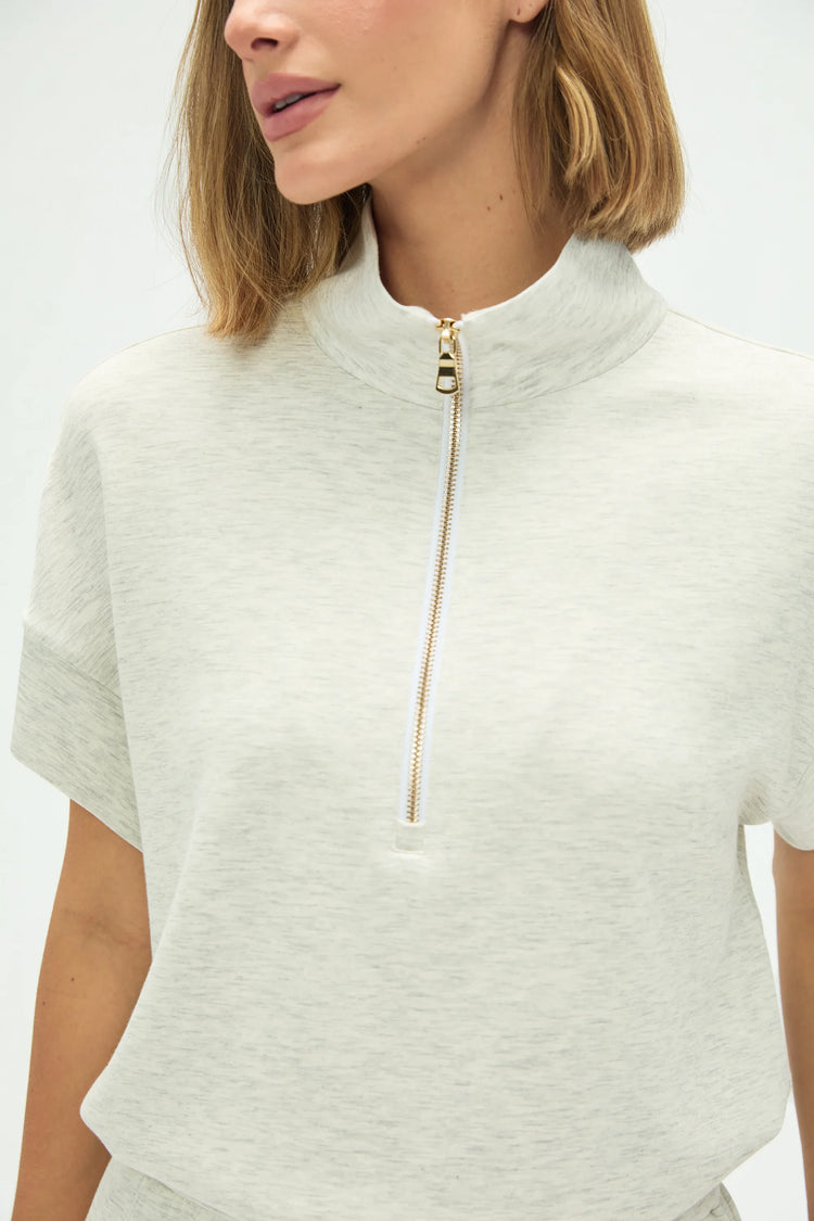 Close-up of the mock neck and half-zip detail on a Tencel™ lounge polo