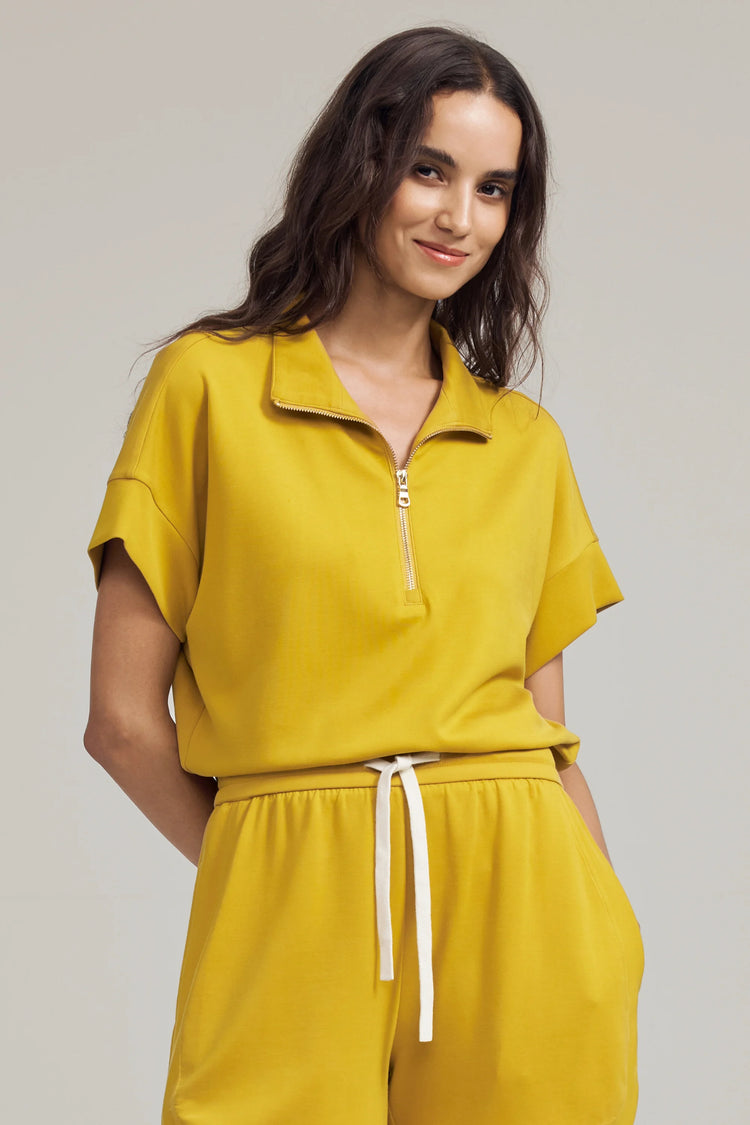 Front view of a short-sleeve half-zip sweat in yellow with a relaxed fit
