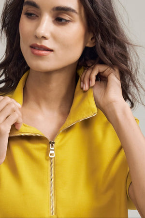 Close-up of the mock neck and half-zip detail on a Tencel™ lounge polo