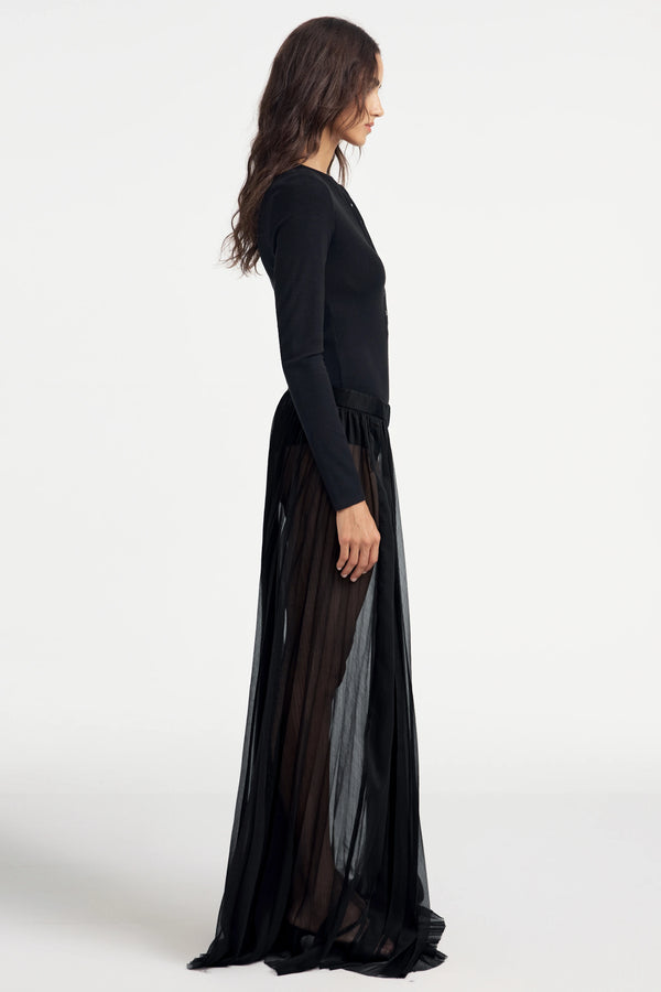 Jet black long-sleeve Henley bodysuit styled with skirt, side profile highlighting slim fit