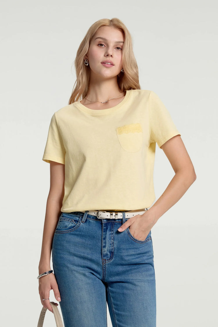 Women’s sunbeam yellow lace-trim pocket tee styled with blue jeans, upper-body front view