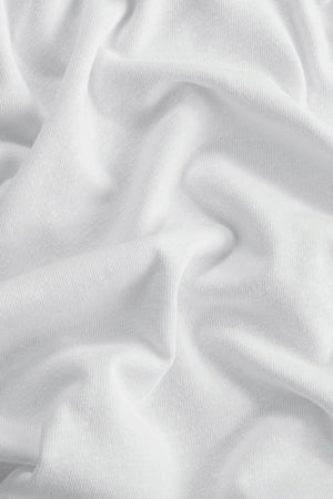 Close-up of cloud white linen Supima cotton tee fabric showing smooth texture and subtle structure