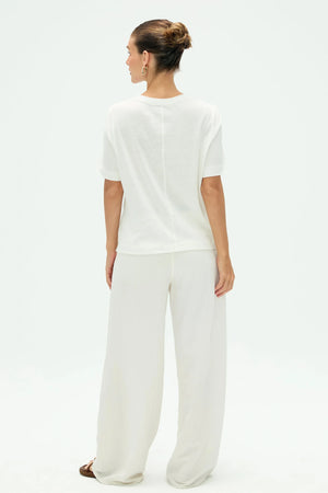 Back view of women’s cloud white linen Supima cotton tee with clean, minimal lines