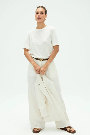 Women’s cloud white linen Supima cotton crewneck tee styled with white pants for a clean full-body look