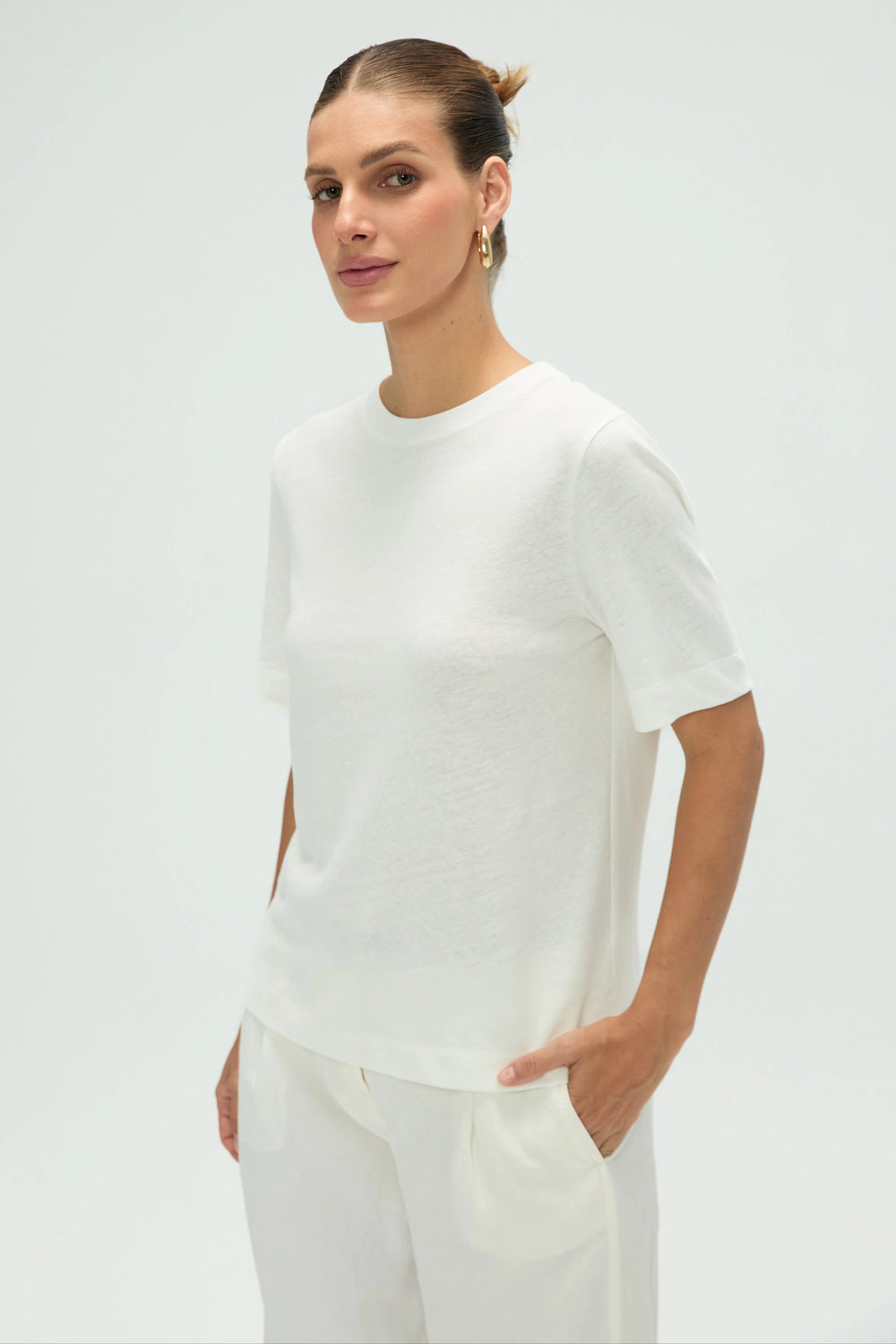 Women’s cloud white linen Supima cotton crewneck tee styled with white pants, upper-body front view