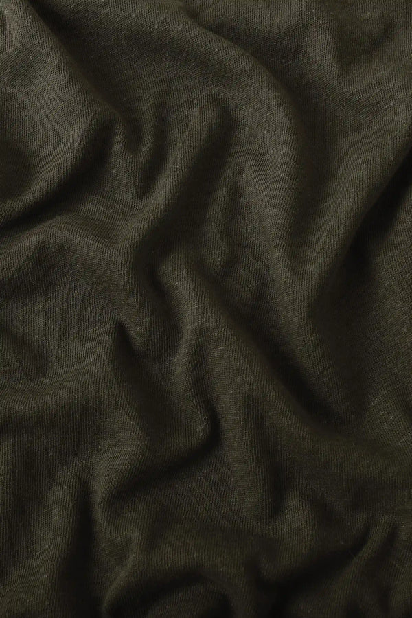 Close-up of espresso linen Supima cotton tee fabric showing smooth texture and subtle structure