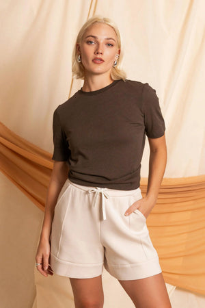 Women’s espresso linen Supima cotton tee paired with beige shorts, clean front silhouette