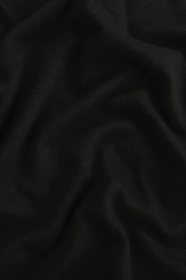Close-up of noir black linen Supima cotton tee fabric showing smooth texture and subtle structure