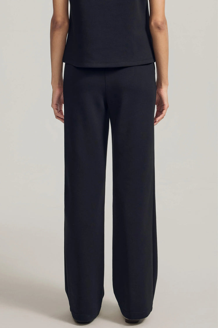Back view of black high-rise flare pants with a refined, streamlined fit
