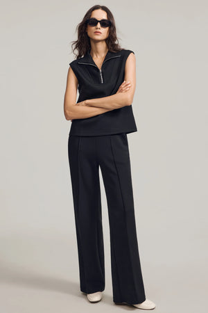 Black luxe flare pants styled with a matching sweatshirt for polished everyday wear