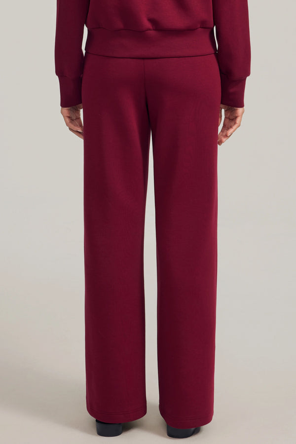 Back view of wool-blend flare pants showing a smooth drape and refined fit