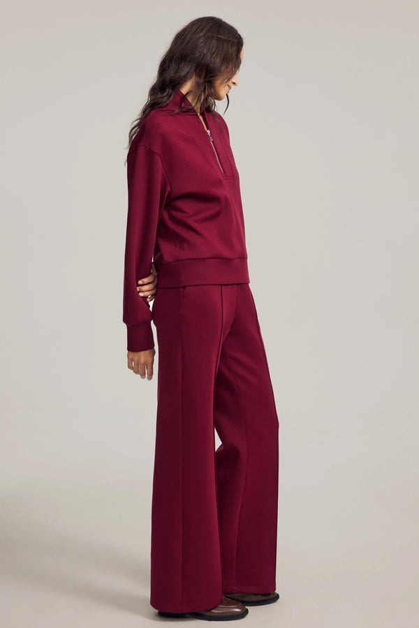 Side view of wide-leg flare pants emphasizing fluid movement and soft structure