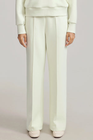 Front view of luxe flare pants in pistachio cream featuring a high-rise, wide-leg silhouette