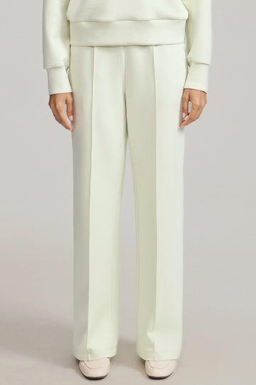 Front view of luxe flare pants in pistachio cream featuring a high-rise, wide-leg silhouette