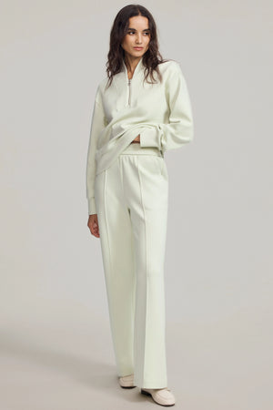 High-rise flare pants in cream green designed for polished everyday wear