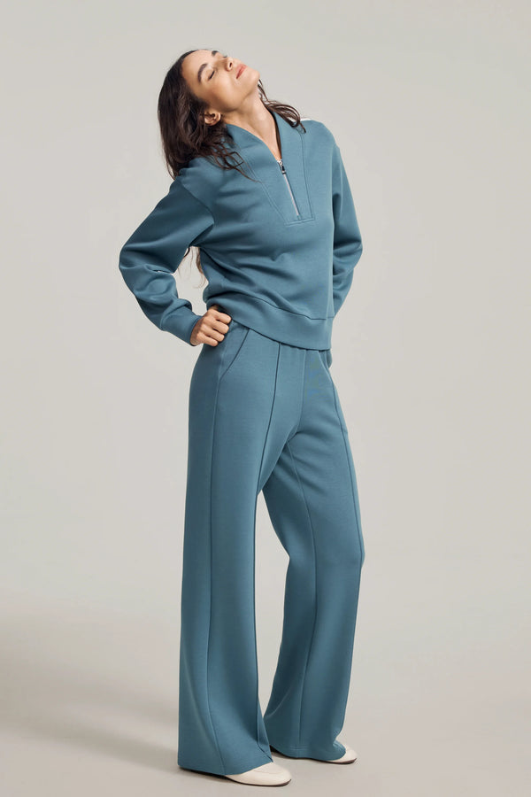 Slate Blue luxe flare pants styled with a matching sweatshirt, front view on grey background