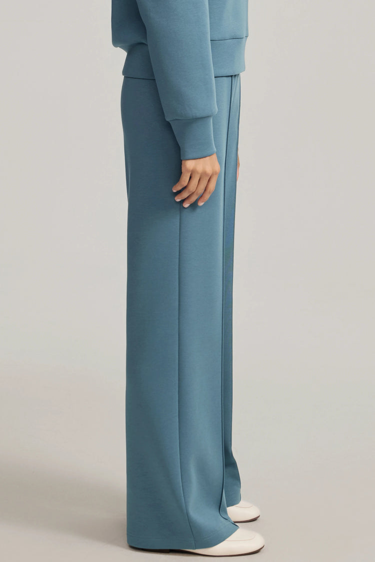 Wide-leg flare pants in Slate Blue shown from the side, emphasizing soft movement