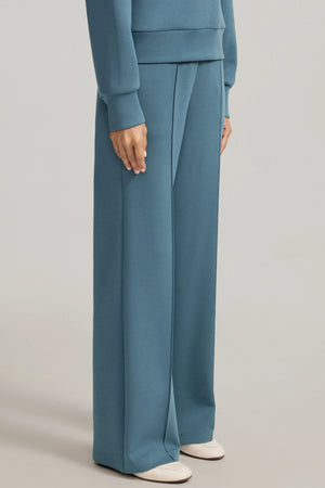 Side view of Slate Blue high-rise flare pants with a smooth, fluid drape