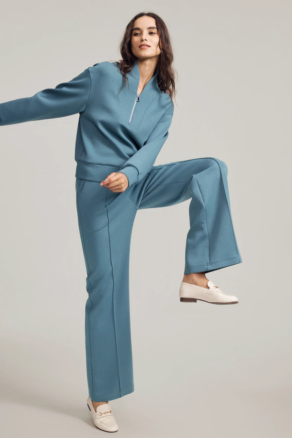 Side view of Slate Blue wool-blend flare pants styled with a matching sweatshirt